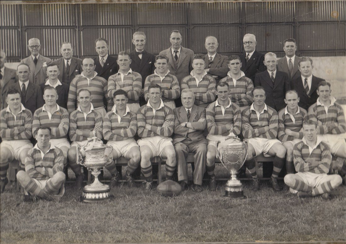 Warrington RLFC championship squad of 1948, photographed with two trophies